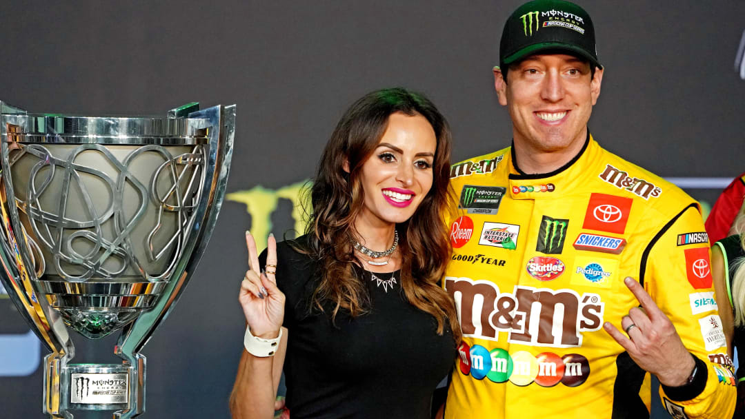 NASCAR Cup Series driver Kyle Busch (18) celebrates after winning the NASCAR Series Cup Championship with his wife Samantha Busch after the Ford EcoBoost 400 at Homestead-Miami Speedway. 