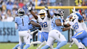 Nov 2, 2025; Nashville, Tennessee, USA; Los Angeles Chargers defensive tackle Justin Eboigbe (92) rushes Tennessee Titans quarterback Cam Ward (1) during the first quarter at Nissan Stadium. Mandatory Credit: Steve Roberts-Imagn Images