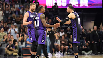 Apr 11, 2025; Sacramento, California, USA; Sacramento Kings forward DeMar DeRozan (10) talks with forward Domantas Sabonis (left) and guard Zach LaVine (8) during the fourth quarter against the Los Angeles Clippers at Golden 1 Center. Mandatory Credit: Darren Yamashita-Imagn Images