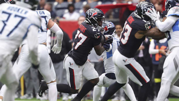 Sep 28, 2025; Houston, Texas, USA; Houston Texans running back Woody Marks (27) runs with the ball and scores a touchdown dur