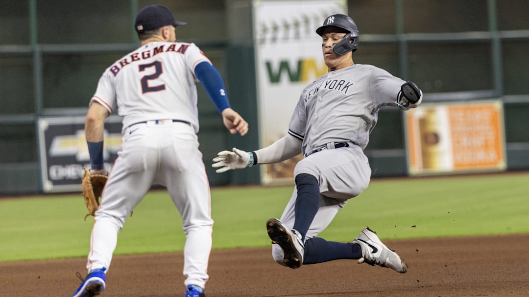 Sep 2, 2023; Houston, Texas, USA; New York Yankees right fielder Aaron Judge (99) slides safely into third base against Houston Astros third baseman Alex Bregman (2) in the fifth inning at Minute Maid Park