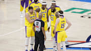 Apr 8, 2025; Oklahoma City, Oklahoma, USA; Los Angeles Lakers guard Luka Doncic (77), forward Jarred Vanderbilt (2), forward LeBron James (23), and guard Austin Reaves (15) talk to an official during a time out in the second half of a game against the Oklahoma City Thunder at Paycom Center. Mandatory Credit: Alonzo Adams-Imagn Images