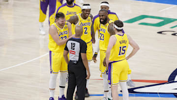 Apr 8, 2025; Oklahoma City, Oklahoma, USA; Los Angeles Lakers guard Luka Doncic (77), forward Jarred Vanderbilt (2), forward LeBron James (23), and guard Austin Reaves (15) talk to an official during a time out in the second half of a game against the Oklahoma City Thunder at Paycom Center. Mandatory Credit: Alonzo Adams-Imagn Images