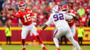 Oct 16, 2022; Kansas City, Missouri, USA; Kansas City Chiefs quarterback Patrick Mahomes (15) throws a pass as Buffalo Bills defensive tackle DaQuan Jones (92) defends during the second half at GEHA Field at Arrowhead Stadium. Mandatory Credit: Jay Biggerstaff-USA TODAY Sports