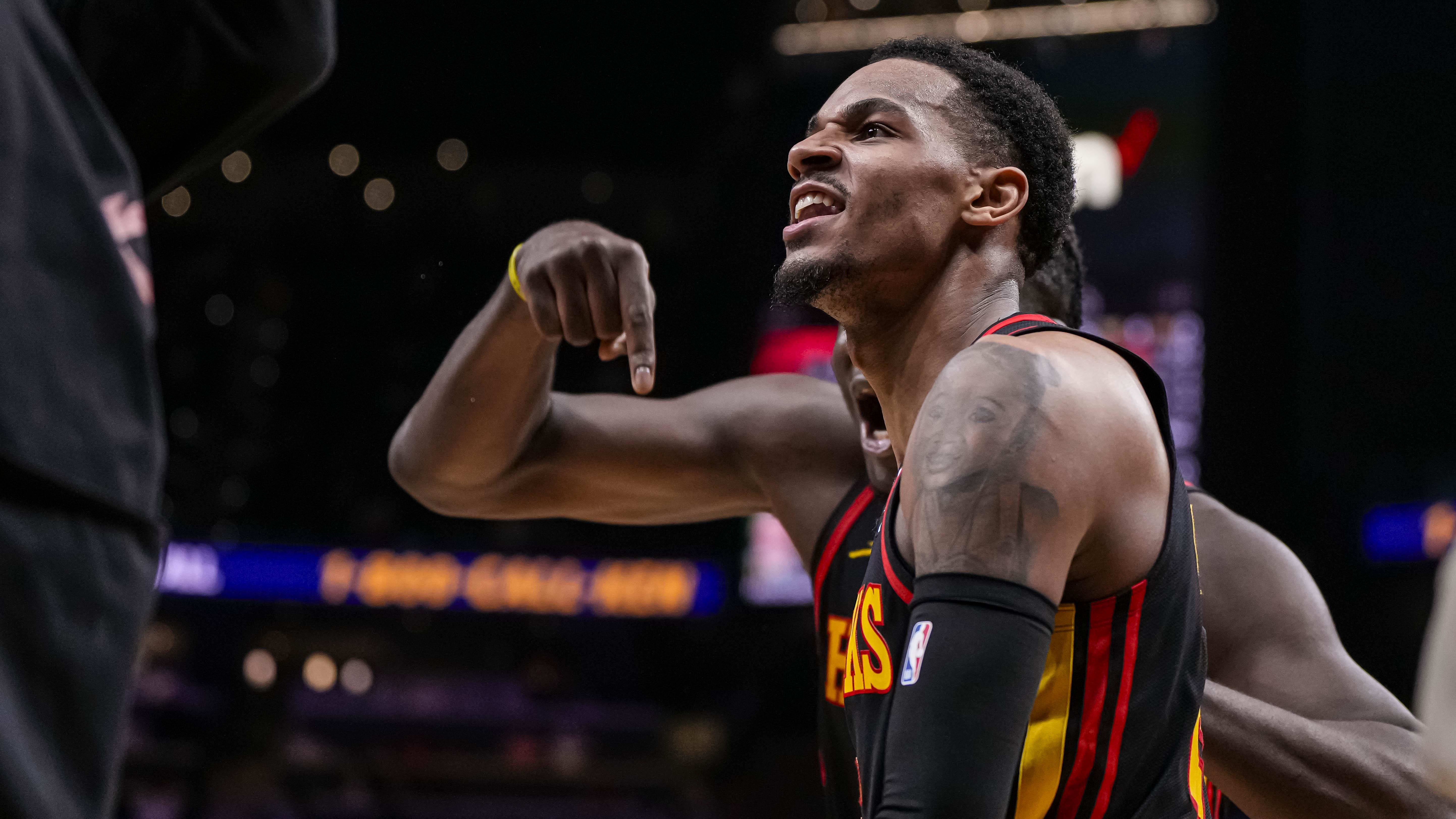 Mar 28, 2024; Atlanta, Georgia, USA; Atlanta Hawks guard Dejounte Murray (5) reacts after making a