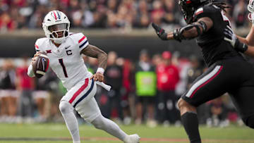 Nov 15, 2025; Cincinnati, Ohio, USA;  Arizona Wildcats quarterback Noah Fifita (1) runs with the ball as he looks to pass against the Cincinnati Bearcats in the first half at Nippert Stadium. Mandatory Credit: Aaron Doster-Imagn Images