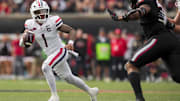 Nov 15, 2025; Cincinnati, Ohio, USA;  Arizona Wildcats quarterback Noah Fifita (1) runs with the ball as he looks to pass against the Cincinnati Bearcats in the first half at Nippert Stadium. Mandatory Credit: Aaron Doster-Imagn Images