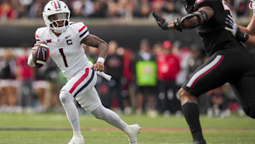 Nov 15, 2025; Cincinnati, Ohio, USA;  Arizona Wildcats quarterback Noah Fifita (1) runs with the ball as he looks to pass against the Cincinnati Bearcats in the first half at Nippert Stadium. Mandatory Credit: Aaron Doster-Imagn Images