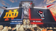 Oct 11, 2025; South Bend, Indiana, USA; Notre Dame Fighting Irish and NC State Wolfpack logos on the scoreboard before the matchup at Notre Dame Stadium. Mandatory Credit: Michael Caterina-Imagn Images
