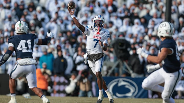 Dec 21, 2024; University Park, Pennsylvania, USA; Southern Methodist Mustangs quarterback Kevin Jennings (7) throws an interception to Penn State Nittany Lions linebacker Tony Rojas (not pictured) during the first half at Beaver Stadium. Mandatory Credit: Vincent Carchietta-Imagn Images