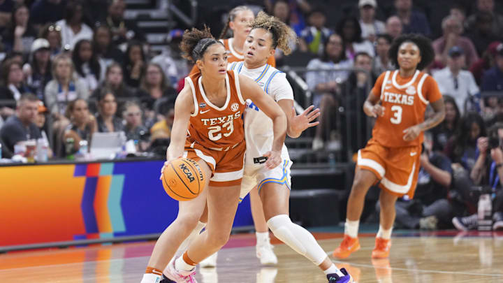 Apr 3, 2026; Phoenix, AZ, USA; Texas Longhorns guard Aaliyah Crump (23) dribbles against UCLA Bruins guard Kiki Rice (1) during the first half of a semifinal of the Final Four of the women's 2026 NCAA Tournament at Mortgage Matchup Center. Mandatory Credit: Joe Camporeale-Imagn Images