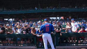 Mar 12, 2023; Mesa, Arizona, USA; Chicago Cubs outfielder Ian Happ (8) signs autographs for fans