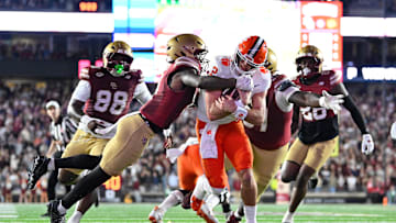 Oct 11, 2025; Chestnut Hill, Massachusetts, USA; Clemson Tigers quarterback Cade Klubnik (2) runs through a tackle by Boston College Eagles defensive back Max Tucker (3) for a touchdown during the first half at Alumni Stadium. Mandatory Credit: Eric Canha-Imagn Images