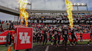 The Houston Cougars run out onto the field before playing against the West Virginia Mountaineers at TDECU Stadium. 