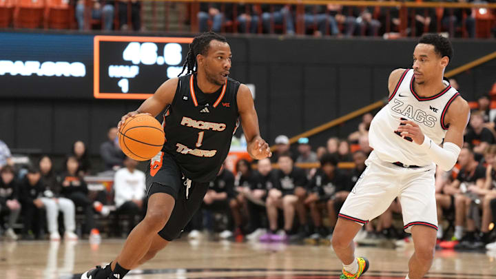 Feb 8, 2025; Stockton, California, USA; Pacific Tigers guard Lamar Washington (1) dribbles against Gonzaga Bulldogs guard Nolan Hickman (right) during the first half at Alex G. Spanos Center. Mandatory Credit: Darren Yamashita-Imagn Images