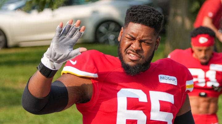 Jul 26, 2024; Kansas City, MO, USA; Kansas City Chiefs guard Trey Smith (65) waves to fans while walking from the locker room to the fields prior to training camp at Missouri Western State University. Mandatory Credit: Denny Medley-USA TODAY Sports