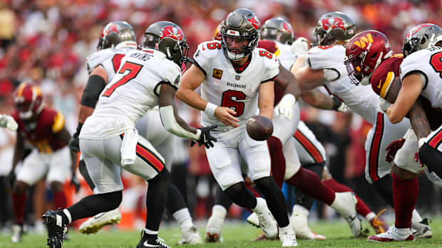 Tampa Bay Buccaneers quarterback Baker Mayfield (6) hands off to running back Bucky Irving (7) against the Washington Command