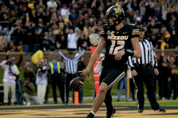 Missouri Tigers quarterback Brady Cook celebrates in the end zone after a rushing touchdown against the Tennessee Volunteers.