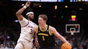 Mar 28, 2025; Atlanta, GA, USA; Michigan Wolverines center Danny Wolf (1) drives against Auburn Tigers forward Chaney Johnson (31) in the second half of a South Regional semifinal of the 2025 NCAA tournament at State Farm Arena. Mandatory Credit: Brett Davis-Imagn Images