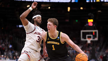 Mar 28, 2025; Atlanta, GA, USA; Michigan Wolverines center Danny Wolf (1) drives against Auburn Tigers forward Chaney Johnson (31) in the second half of a South Regional semifinal of the 2025 NCAA tournament at State Farm Arena. Mandatory Credit: Brett Davis-Imagn Images