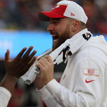 Jan 7, 2024; Inglewood, California, USA; Kansas City Chiefs tight end Travis Kelce (87, right) smiles on the sideline during the NFL game against the Los Angeles Chargers at SoFi Stadium. Mandatory Credit: Kiyoshi Mio-Imagn Images