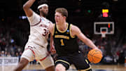 Mar 28, 2025; Atlanta, GA, USA; Michigan Wolverines center Danny Wolf (1) drives against Auburn Tigers forward Chaney Johnson (31) in the second half of a South Regional semifinal of the 2025 NCAA tournament at State Farm Arena. Mandatory Credit: Brett Davis-Imagn Images
