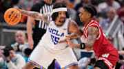 UCLA Bruins guard Skyy Clark (55) rushes up the court against Wisconsin Badgers guard Kamari McGee (4) on Friday, March 14, 2025, during the third round of the men's Big Ten tournament at Gainbridge Fieldhouse in Indianapolis.