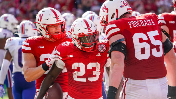 Nebraska Cornhuskers running back Anthony Grant (23) and offensive lineman Teddy Prochazka (65) celebrate after a touchdown by Grant. 