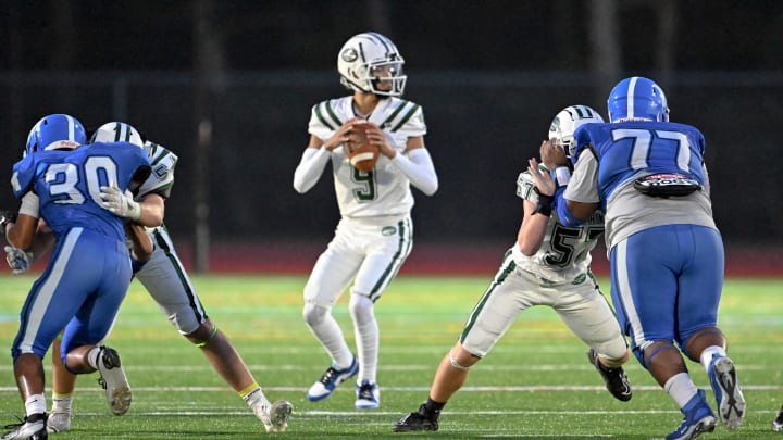 MASHPEE  9/08/23  D-Y quarterback Jayden Barber looks for a receiver pressured by Mashpee.  football