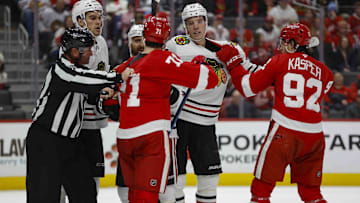 Jan 10, 2025; Detroit, Michigan, USA; Detroit Red Wings center Dylan Larkin (71) scuffles with Chicago Blackhawks defenseman Alex Vlasic (72) during the second period at Little Caesars Arena. Mandatory Credit: Brian Bradshaw Sevald-Imagn Images