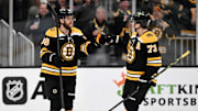 Mar 30, 2023; Boston, Massachusetts, USA; Boston Bruins right wing David Pastrnak (88) reacts with defenseman Charlie McAvoy (73) after scoring a goal against the Columbus Blue Jackets during overtime at the TD Garden. Mandatory Credit: Brian Fluharty-Imagn Images