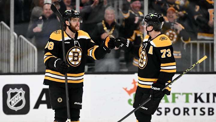Mar 30, 2023; Boston, Massachusetts, USA; Boston Bruins right wing David Pastrnak (88) reacts with defenseman Charlie McAvoy (73) after scoring a goal against the Columbus Blue Jackets during overtime at the TD Garden. Mandatory Credit: Brian Fluharty-Imagn Images