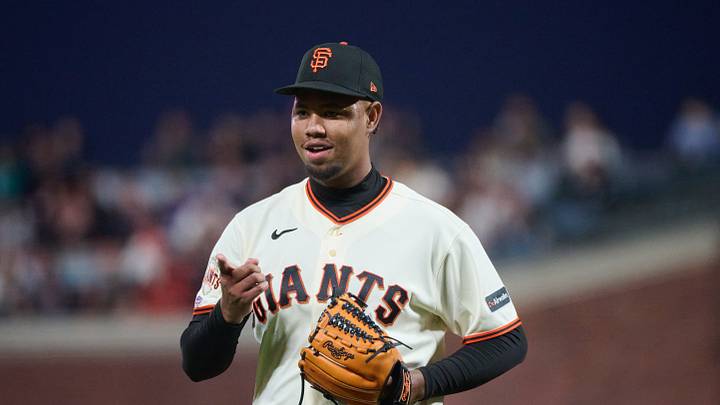 San Francisco, California, USA; San Francisco Giants starting pitcher Yunior Marte (87) reacts while walking to the dugout after the third out of the fourth inning against the Arizona Diamondbacks in his MLB debut at Oracle Park. Mandatory Credit: Robert Edwards-Imagn Images