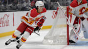 Apr 17, 2025; Los Angeles, California, USA;  Calgary Flames defenseman Zayne Parekh (89) handles the puck during the second period against the Los Angeles Kings at Crypto.com Arena. Mandatory Credit: Jayne Kamin-Oncea-Imagn Images