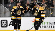 Mar 30, 2023; Boston, Massachusetts, USA; Boston Bruins right wing David Pastrnak (88) reacts with defenseman Charlie McAvoy (73) after scoring a goal against the Columbus Blue Jackets during overtime at the TD Garden. Mandatory Credit: Brian Fluharty-Imagn Images