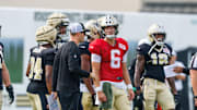 Jul 30, 2025; New Orleans, LA, USA;  New Orleans Saints quarterback Tyler Shough (6) talks to New Orleans Saints quarterback coach Scott Tolzien during training camp at Ochsner Sports Performance Center. Mandatory Credit: Stephen Lew-Imagn Images