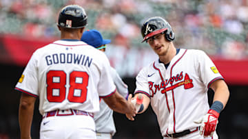 Aug 24, 2025; Cumberland, Georgia, USA; Atlanta Braves catcher Sean Murphy (12) celebrates at first base with Atlanta Braves first base coach Tom Goodwin (88) after a hit against the New York Mets during the second inning at Truist Park. Mandatory Credit: Jordan Godfree-Imagn Images
