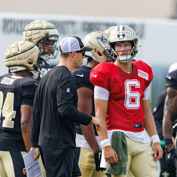 Jul 30, 2025; New Orleans, LA, USA;  New Orleans Saints quarterback Tyler Shough (6) talks to New Orleans Saints quarterback coach Scott Tolzien during training camp at Ochsner Sports Performance Center. Mandatory Credit: Stephen Lew-Imagn Images