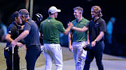 Tommy Fleetwood of Los Angeles Golf Club, right, Rory McIlroy and Adam Scott of Boston Common Golf and Justin Rose and Collin Morikawa greet each other at the end of their TGL golf match at the SoFi Center on February 4, 2025, in Palm Beach Gardens, Florida.