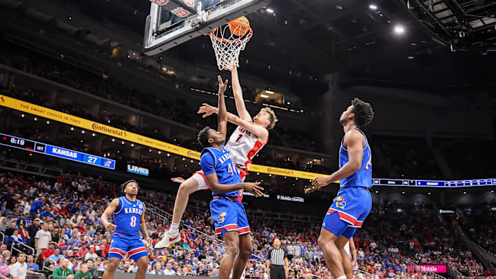 Mar 13, 2025; Kansas City, MO, USA; Arizona Wildcats guard Caleb Love (1) shoots the ball over Kansas Jayhawks forward Flory Bidunga (40) during the first half at T-Mobile Center. Mandatory Credit: William Purnell-Imagn Images