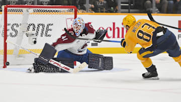 Dec 9, 2025; Nashville, Tennessee, USA;  Colorado Avalanche goaltender Scott Wedgewood (41) blocks the shot of Nashville Predators defenseman Adam Wilsby (83) during the overtime period at Bridgestone Arena. Mandatory Credit: Steve Roberts-Imagn Images