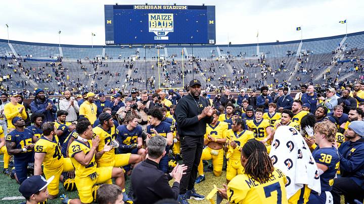 Michigan head coach Sherrone Moore, center, speaks to players after the spring game at Michigan Stadium in Ann Arbor on Saturday, April 19, 2025.