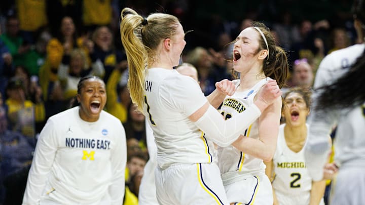 Michigan guard Olivia Olson (1) and guard Syla Swords, right, celebrate Olson scoring a basket and drawing a foul during the first round of the NCAA Women's Basketball Tournament between Michigan and Iowa State at Purcell Pavilion on Friday, March 21, 2025, in South Bend.