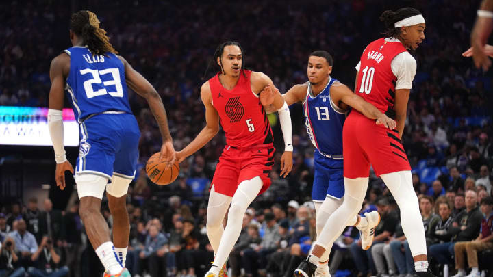 Apr 14, 2024; Sacramento, California, USA; Portland Trail Blazers forward Dalano Banton (5) dribbles the ball in front of Sacramento Kings forward Keegan Murray (13) in the first quarter at the Golden 1 Center. Mandatory Credit: Cary Edmondson-USA TODAY Sports