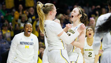 Michigan guard Olivia Olson (1) and guard Syla Swords, right, celebrate Olson scoring a basket and drawing a foul during the first round of the NCAA Women's Basketball Tournament between Michigan and Iowa State at Purcell Pavilion on Friday, March 21, 2025, in South Bend.