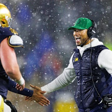 Notre Dame head coach Marcus Freeman, right, celebrates after a touchdown during the second half of a NCAA football game against Navy at Notre Dame Stadium on Saturday, Nov. 8, 2025, in South Bend.