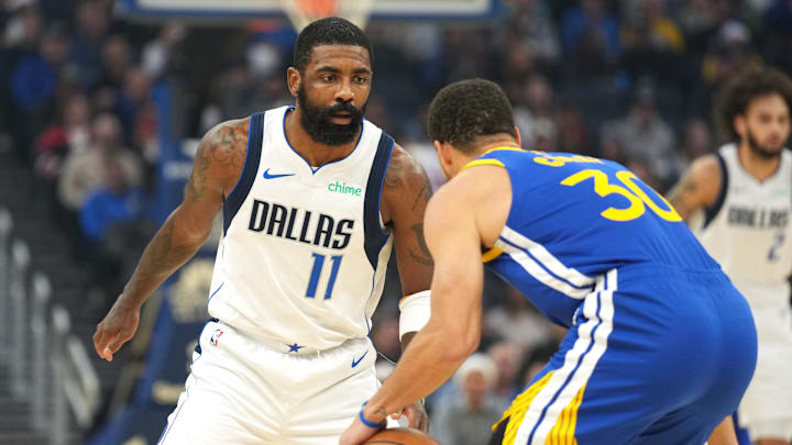 Dec 15, 2024; San Francisco, California, USA; Dallas Mavericks guard Kyrie Irving (11) defends against Golden State Warriors guard Stephen Curry (30) during the first quarter at Chase Center. Mandatory Credit: Darren Yamashita-Imagn Images