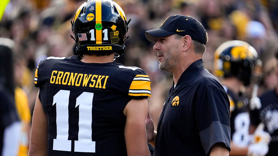 Iowa offensive coordinator Tim Lester talks to Iowa Hawkeyes quarterback Mark Gronowski (11) during warmups Aug. 30, 2025 at Kinnick Stadium in Iowa City, Iowa.