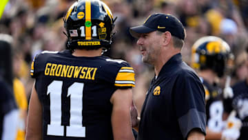 Iowa offensive coordinator Tim Lester talks to Iowa Hawkeyes quarterback Mark Gronowski (11) during warmups Aug. 30, 2025 at Kinnick Stadium in Iowa City, Iowa.