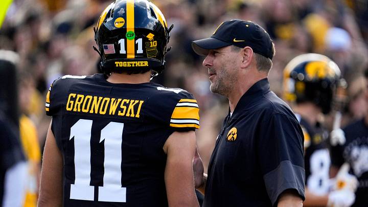 Iowa offensive coordinator Tim Lester talks to Iowa Hawkeyes quarterback Mark Gronowski (11) during warmups Aug. 30, 2025 at Kinnick Stadium in Iowa City, Iowa.